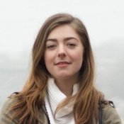 woman smiling with a brown blazer